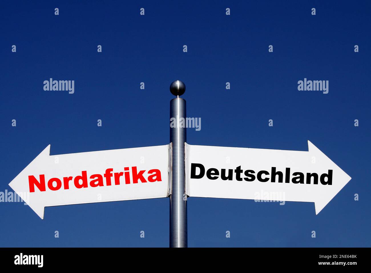signposts pointing in different directions, options North Africa - Germany Stock Photo