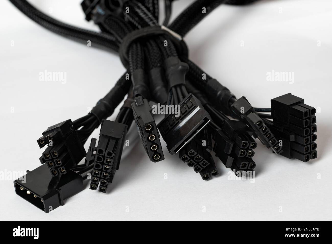 Bundled black modular power supply unit cables set, psu cords put together isolated on white