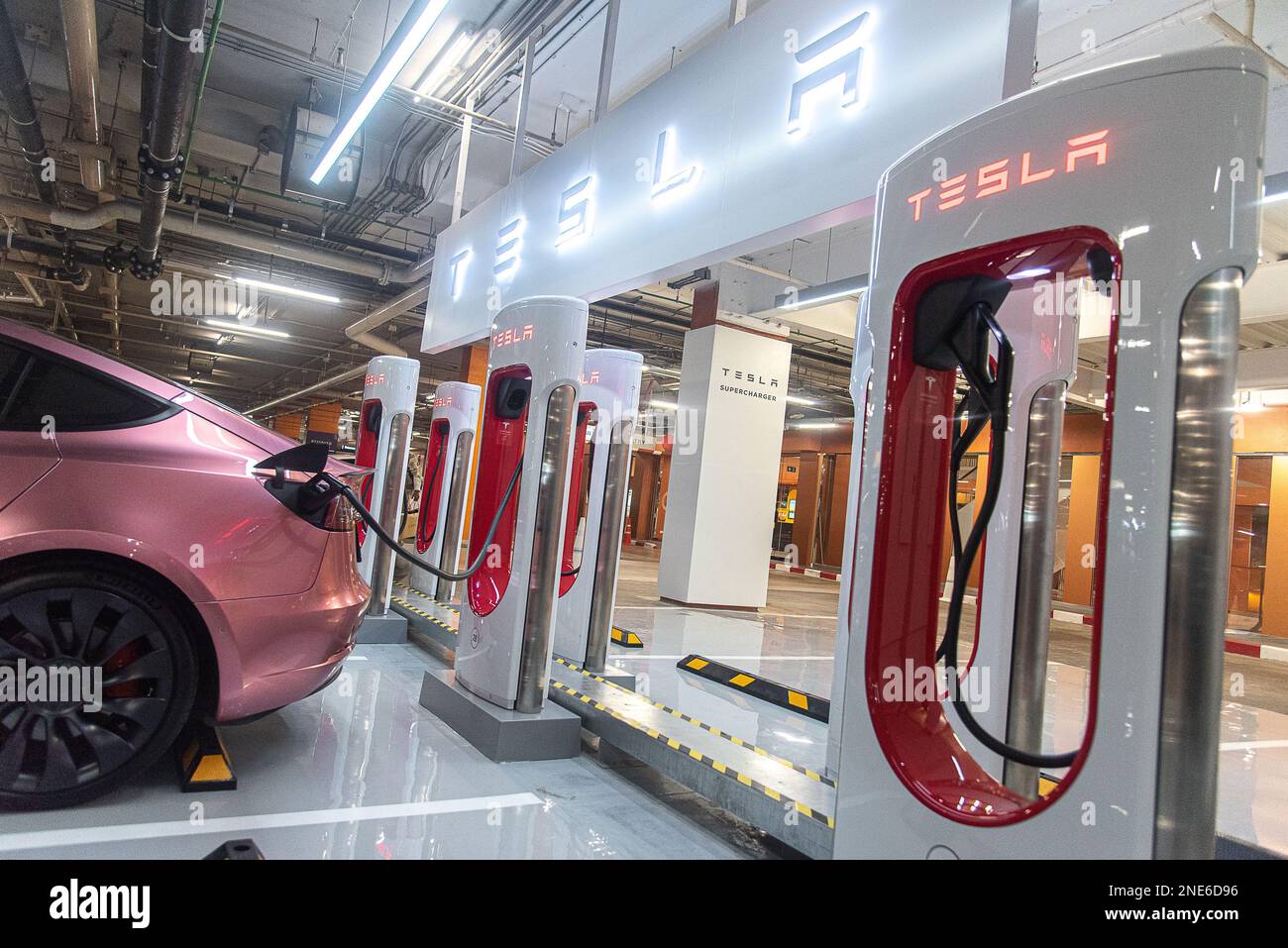A Tesla car is seen plugged into a Tesla Supercharger at Central World