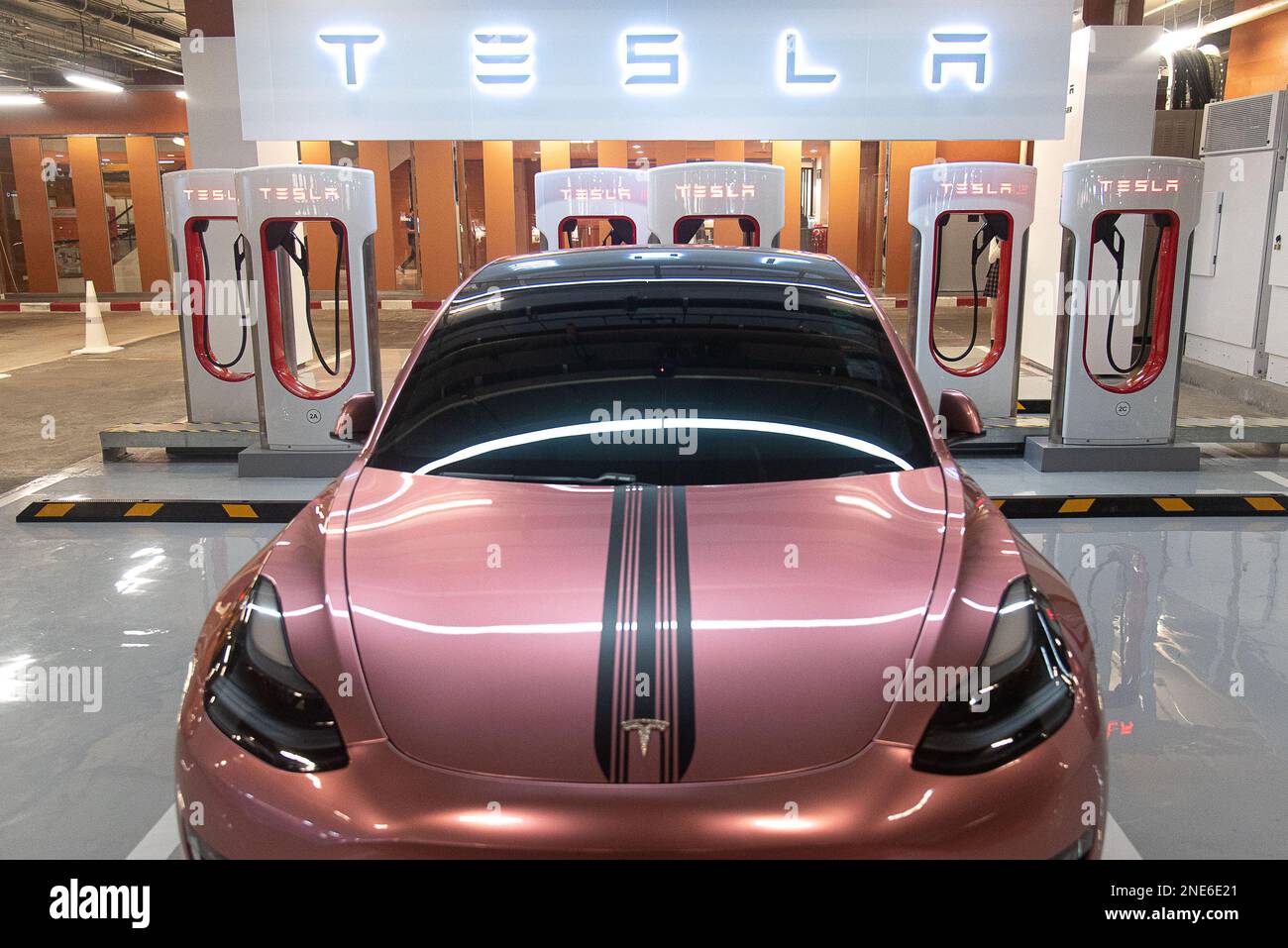 A Tesla car seen charging at the Tesla supercharger station at Central