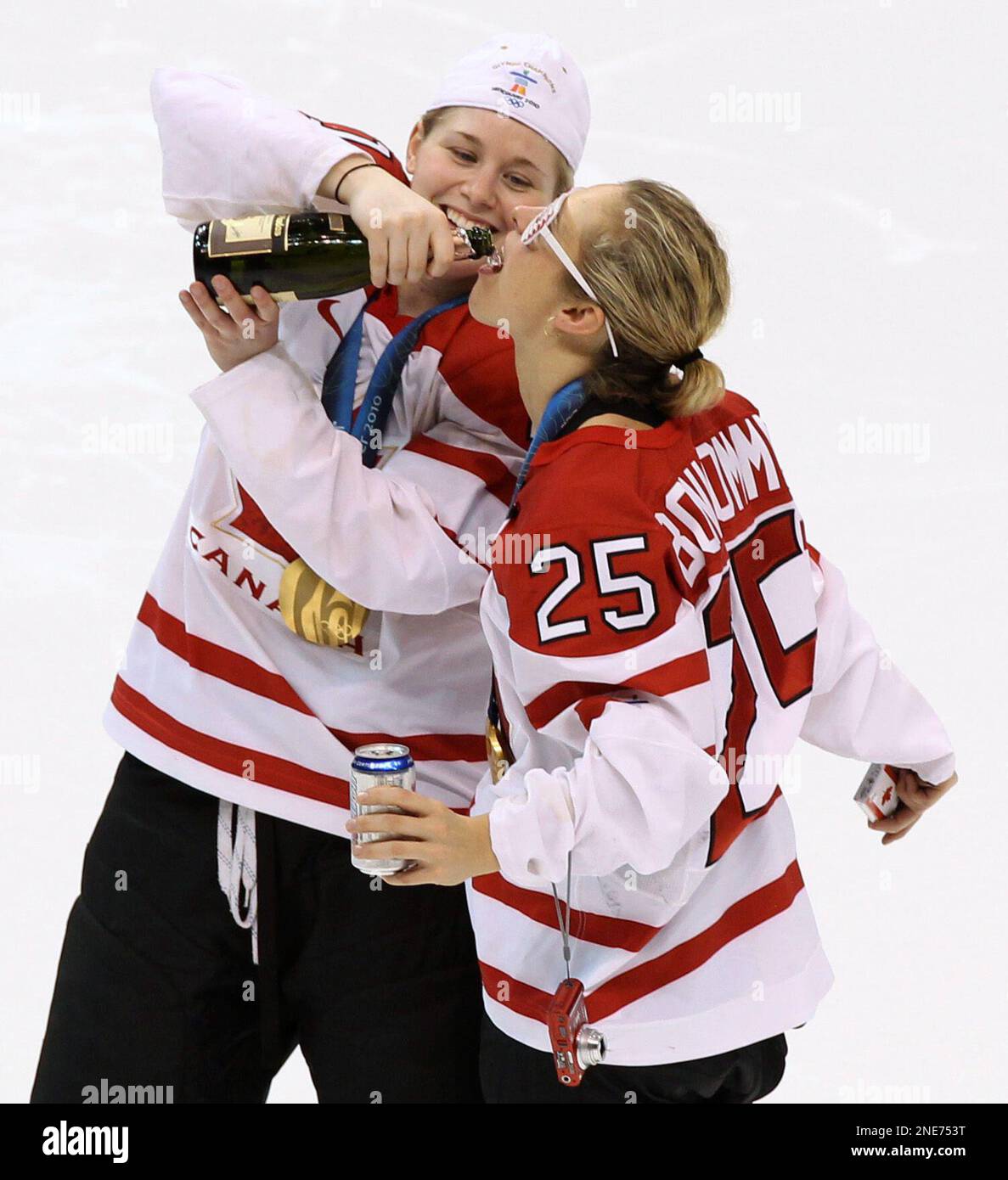Canada's Haley Irwin and Tessa Bonhomme drink at centre ice