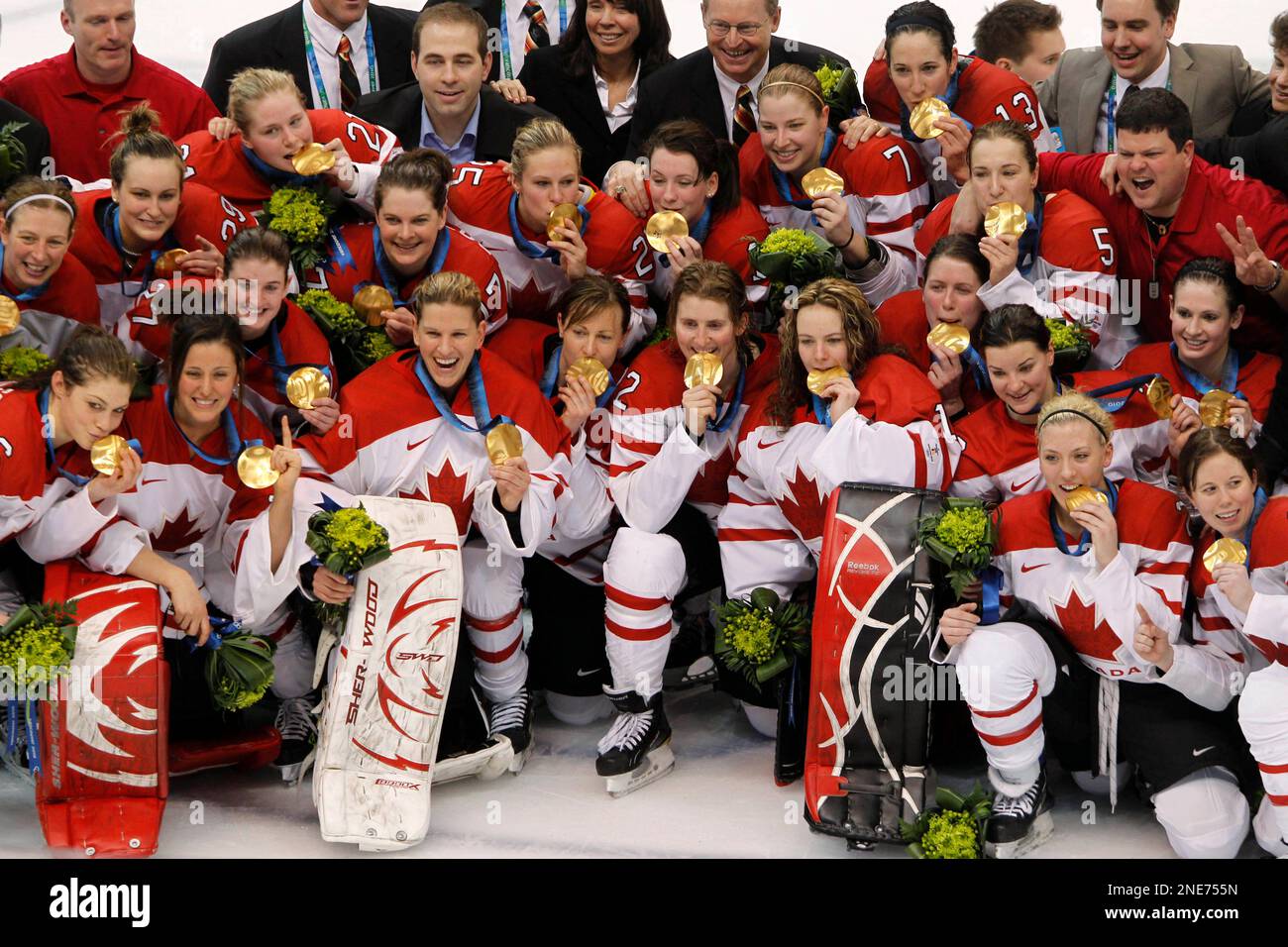 Canadian players pose for a photo with their gold medals after defeating  the USA during the women's final ice hockey game at the Vancouver 2010  Olympics in Vancouver, Thursday Feb. 25, 2010. (