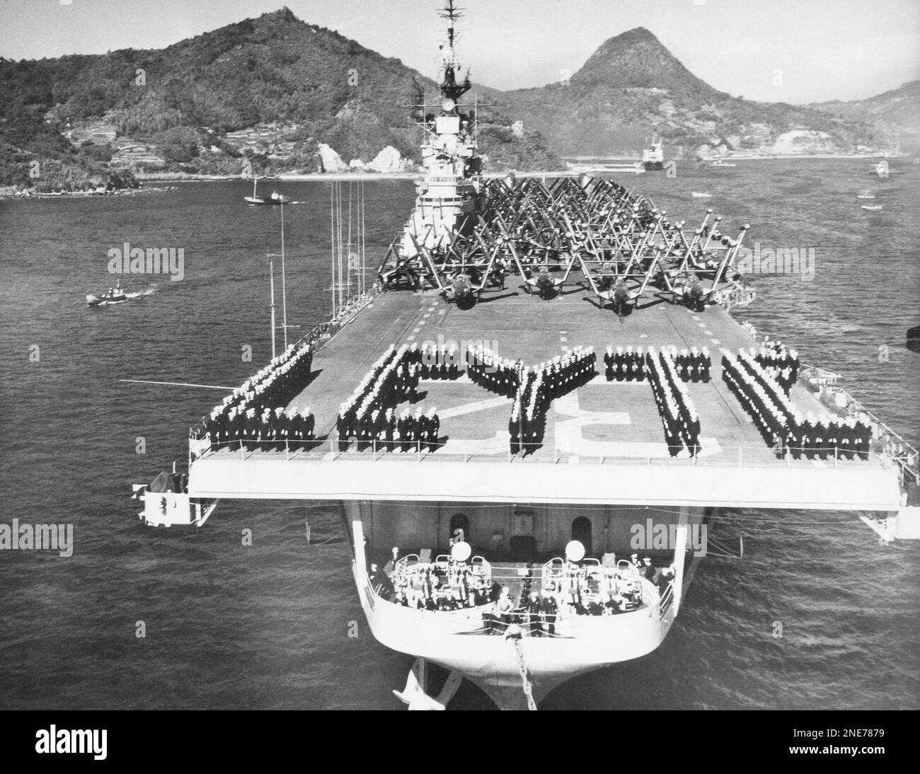 The crew of the mighty carrier USS Leyte forms ?Leyte? on the flight