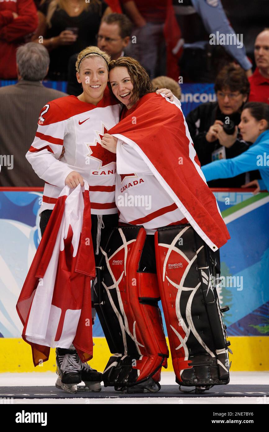 Canada's goalie Shannon Szabados and Marie-Philip Poulin celebrate