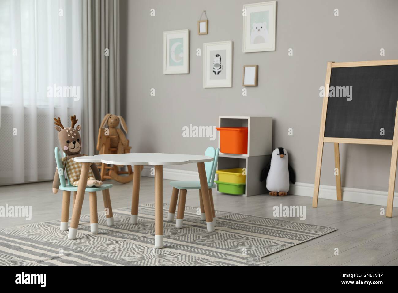 Child's room interior with stylish table, chairs and toys Stock Photo ...