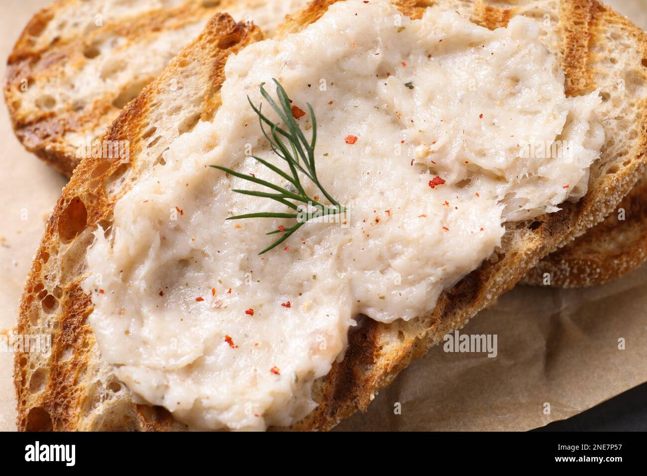 Toast with lard spread on parchment, closeup Stock Photo Alamy