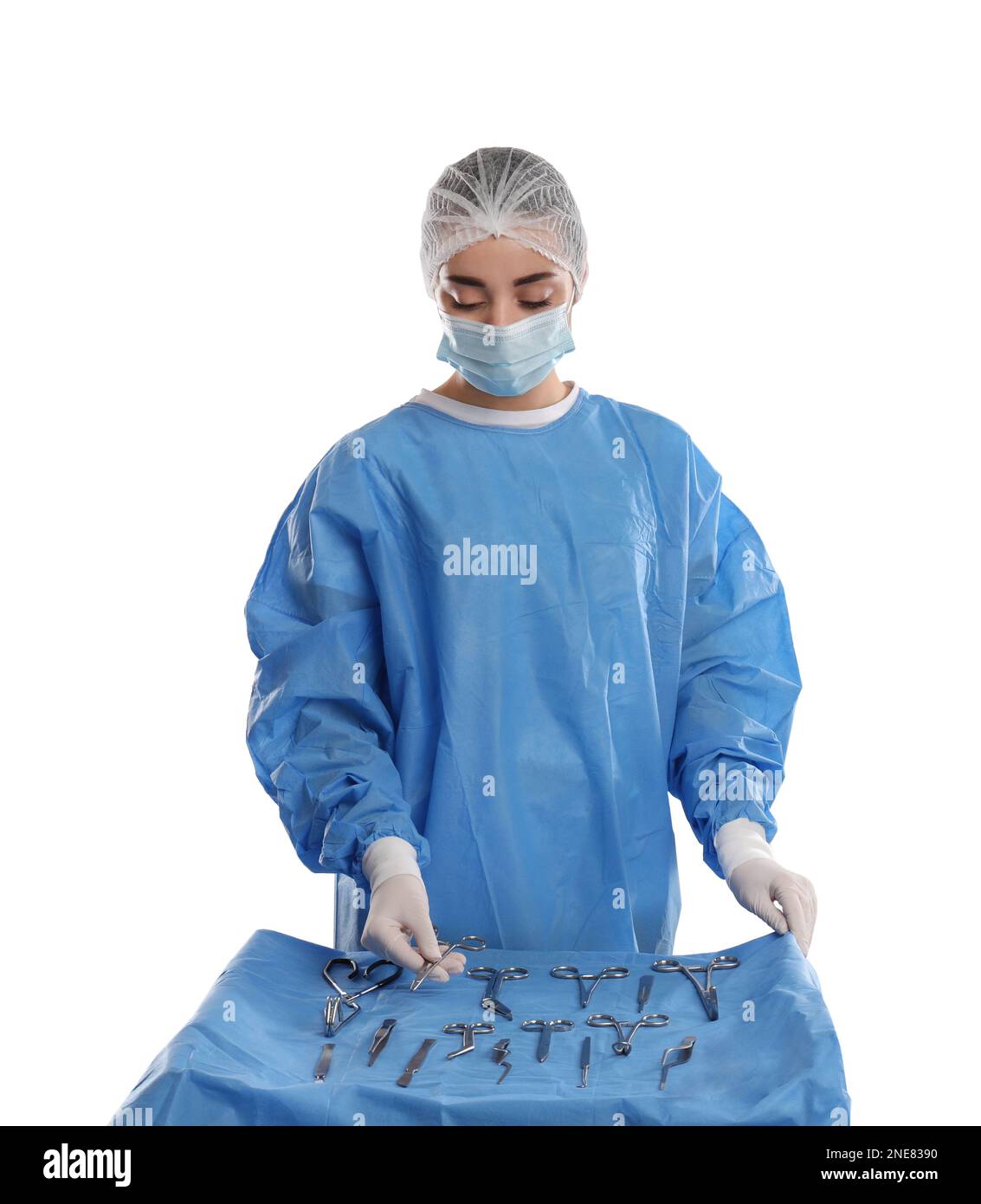 Doctor holding Mayo scissors near table with different surgical