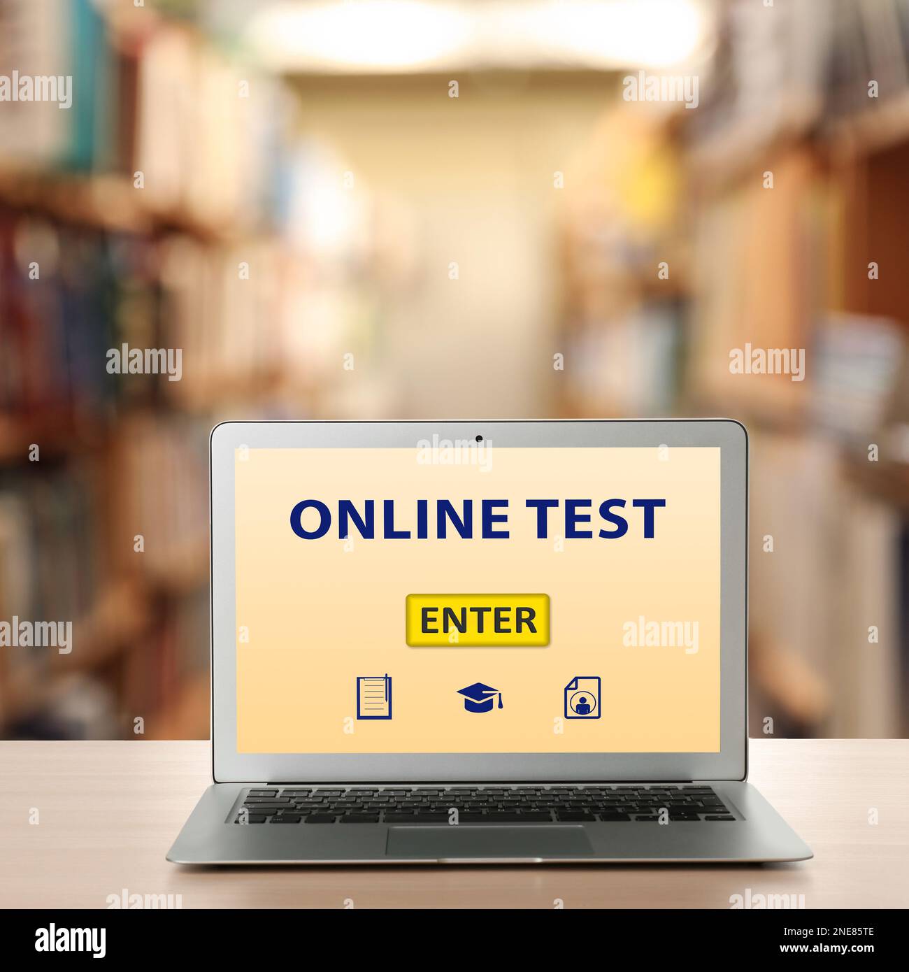 Laptop with online test on screen in library Stock Photo - Alamy