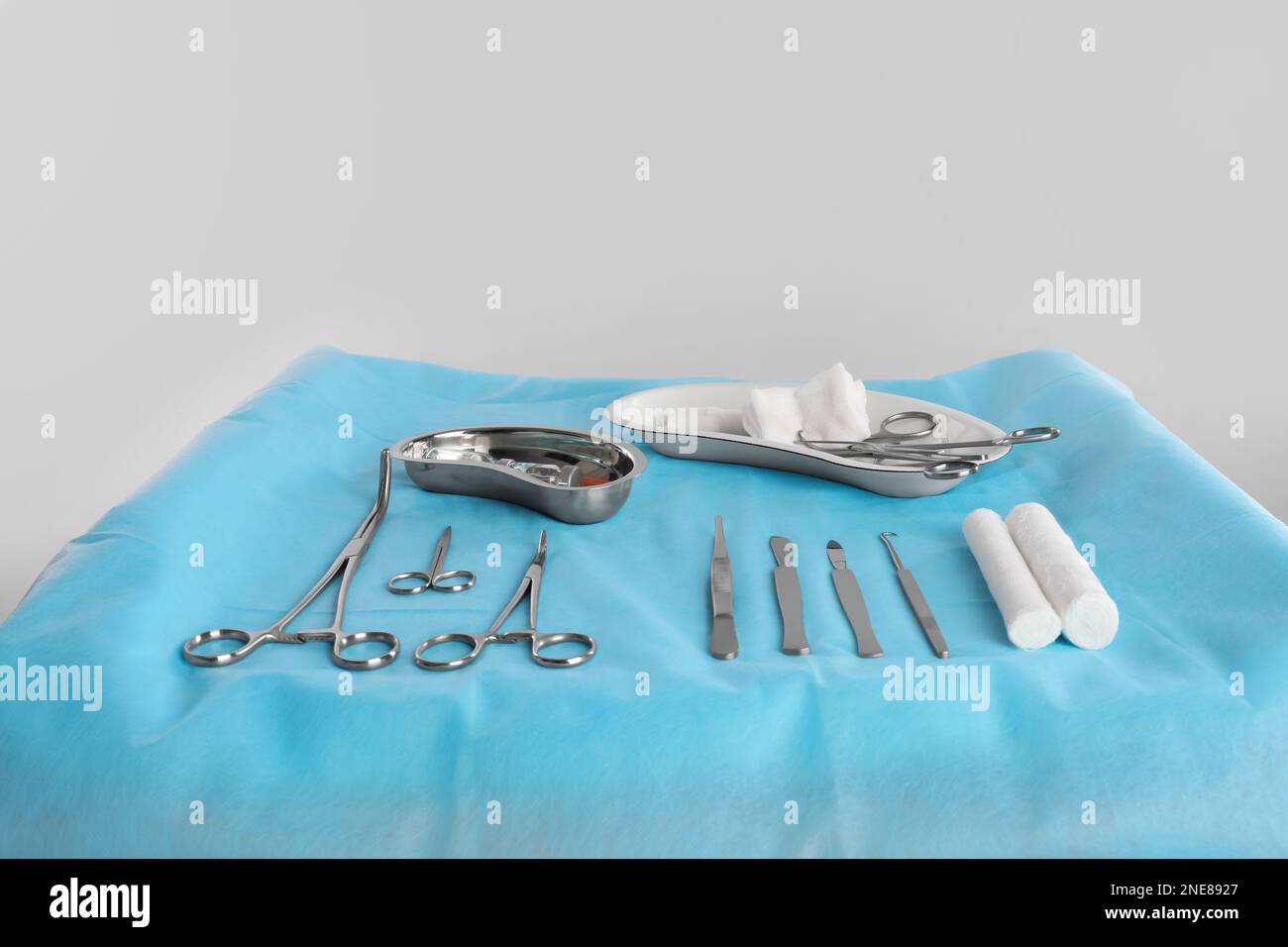 Different surgical instruments on table against light background Stock Photo