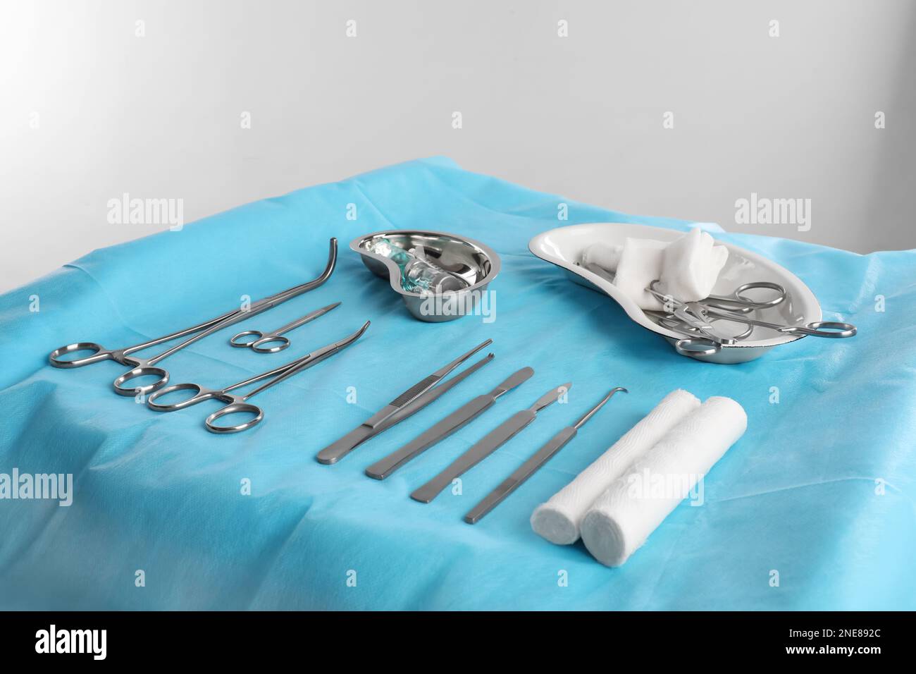 Different surgical instruments on table against light background Stock Photo