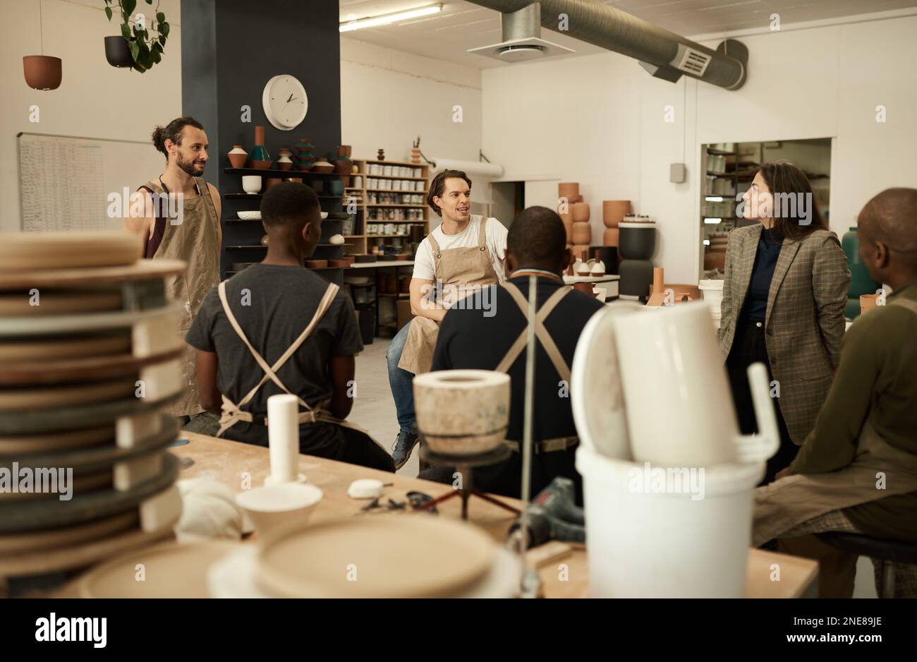 Diverse ceramics studio team talking during a meeting together Stock Photo