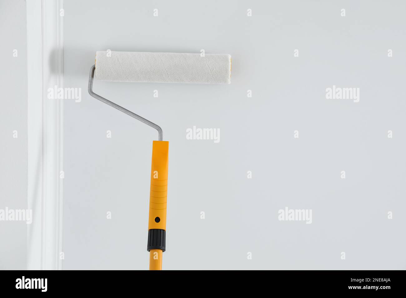 Painting ceiling with white dye indoors, bottom view. Space for text