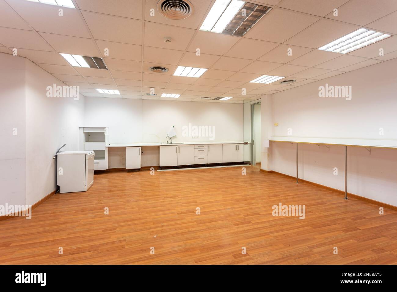 Old empty room with white kitchen furniture and sink that used to serve ...