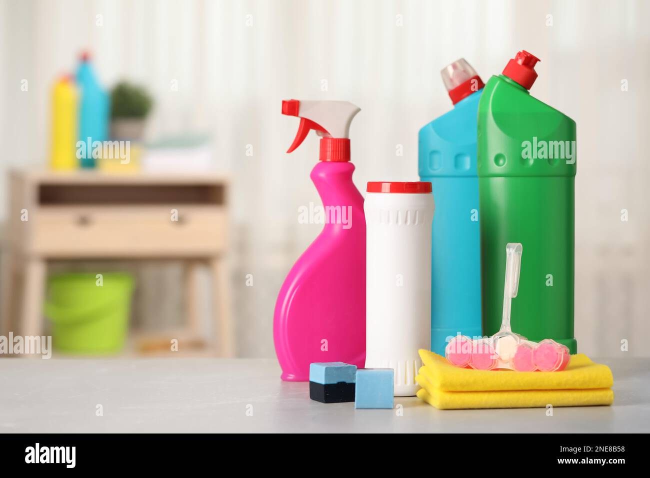 Different toilet cleaning supplies and tools on table indoors, space