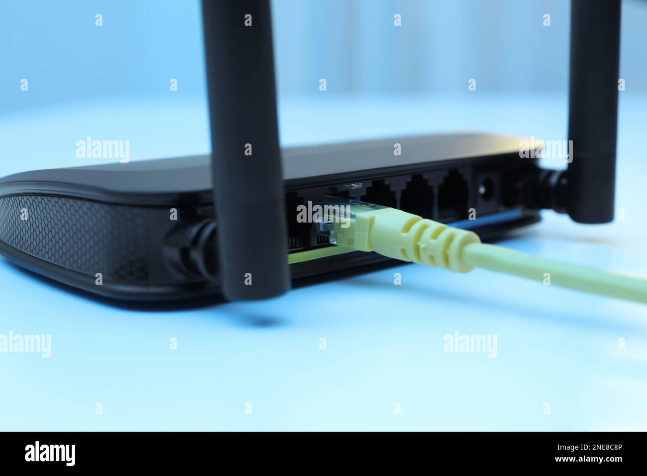 Connected cable to router on white table, closeup. Wireless internet ...