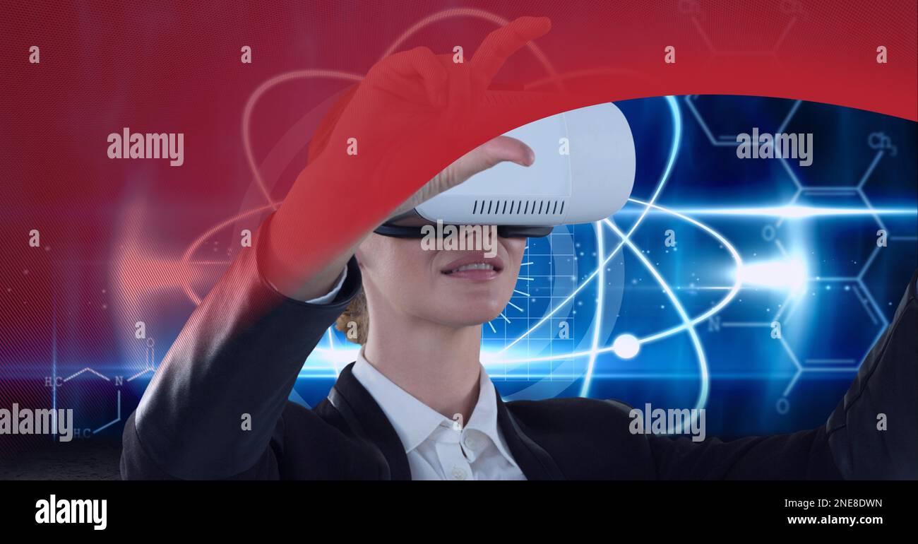Businesswoman wearing vr headset over round scanner against red technology background Stock Photo