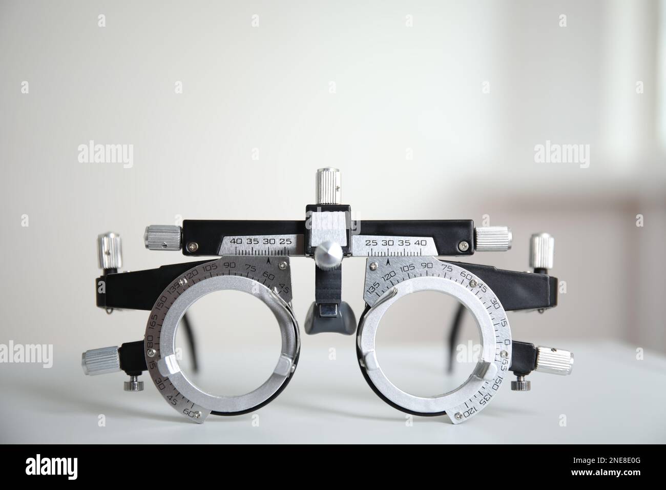 Trial frame on white table. Ophthalmologist tool Stock Photo