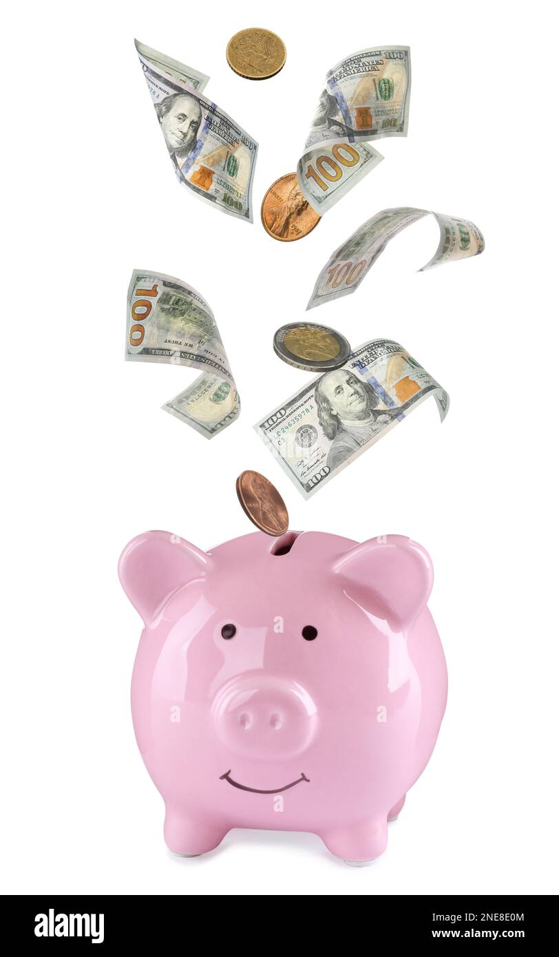 Banknotes and coins falling into piggy bank on white background. Saving ...