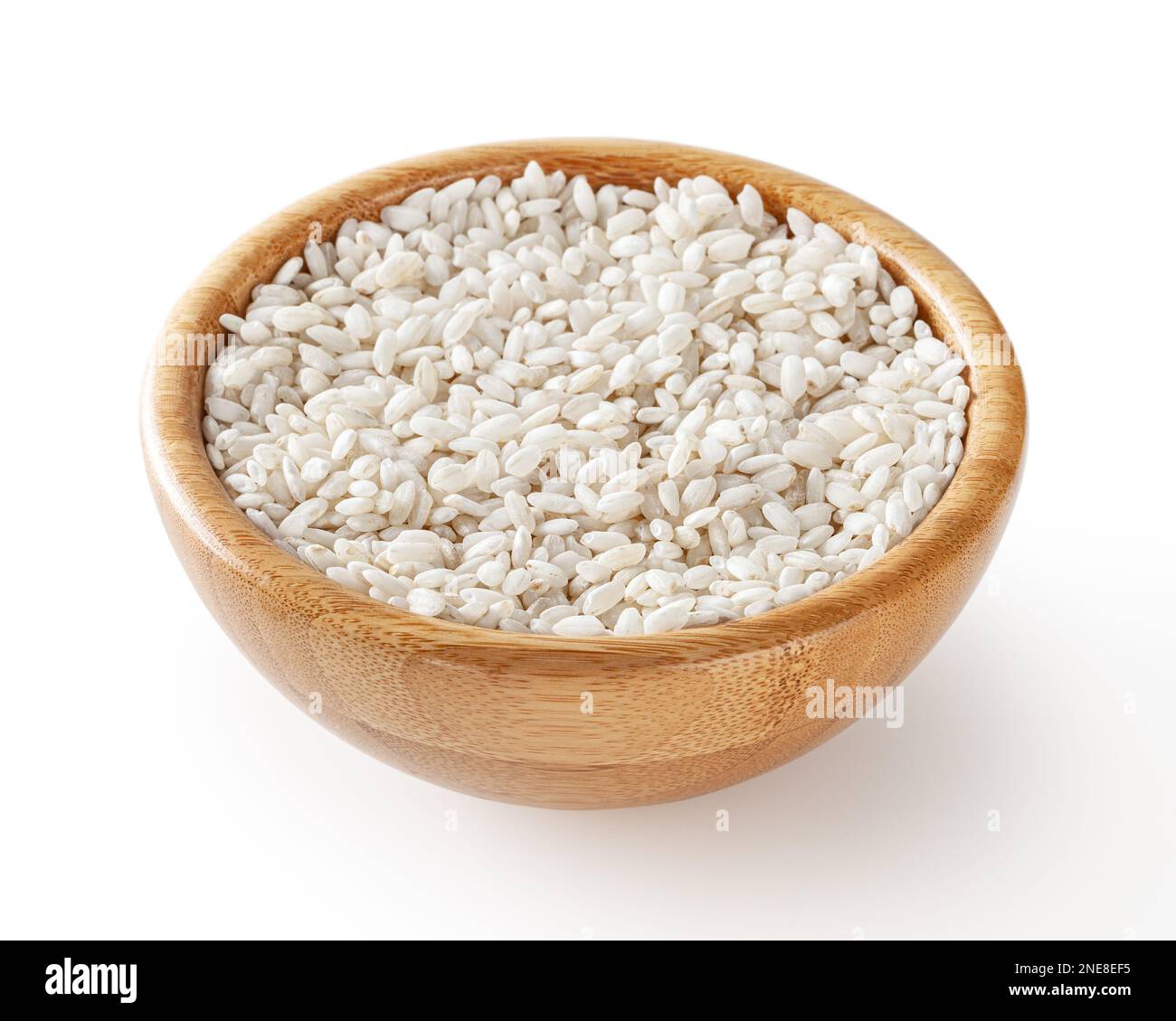 Uncooked arborio rice in wooden bowl isolated on white background with