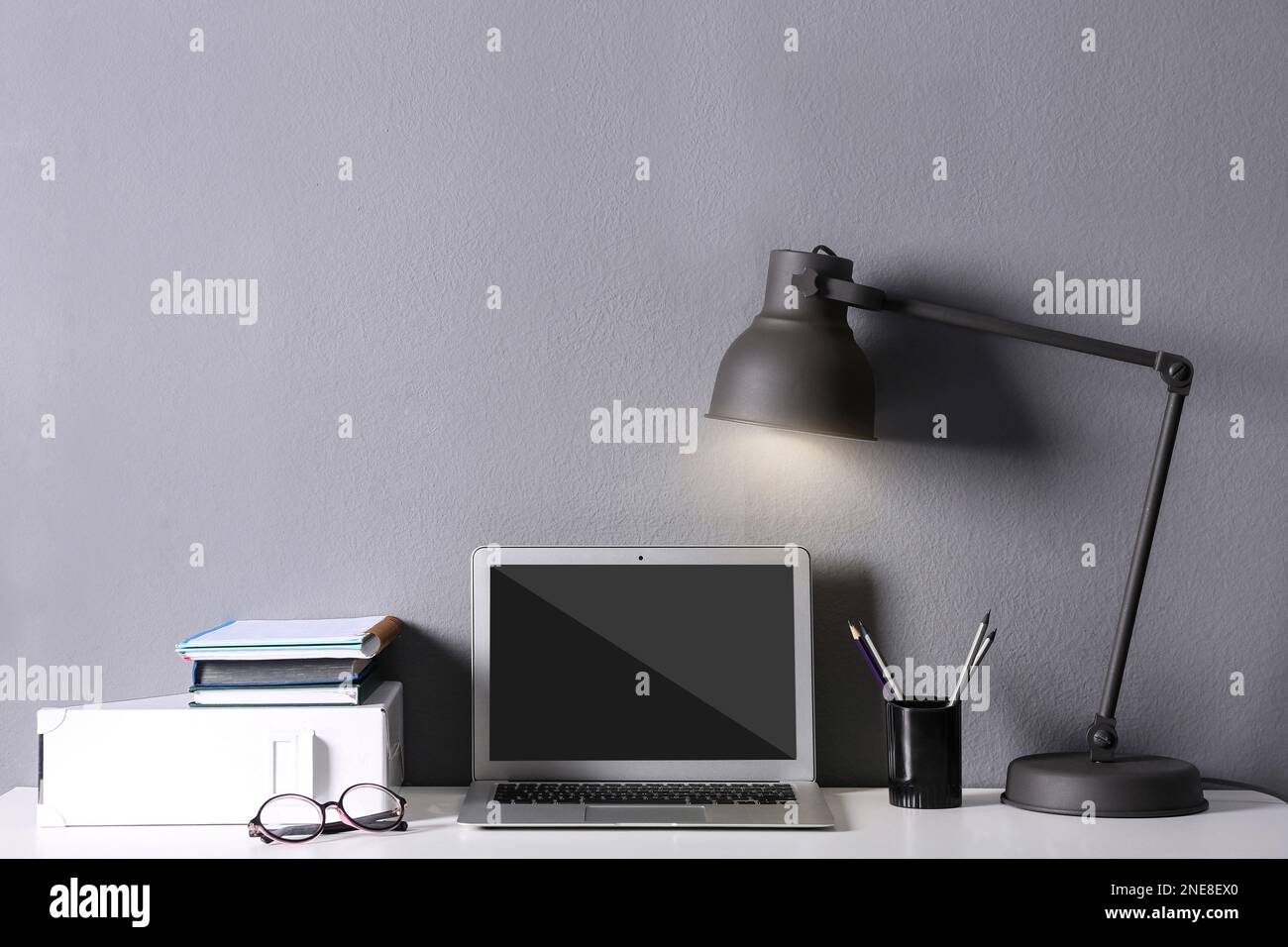 Modern laptop on white table. Comfortable workplace Stock Photo