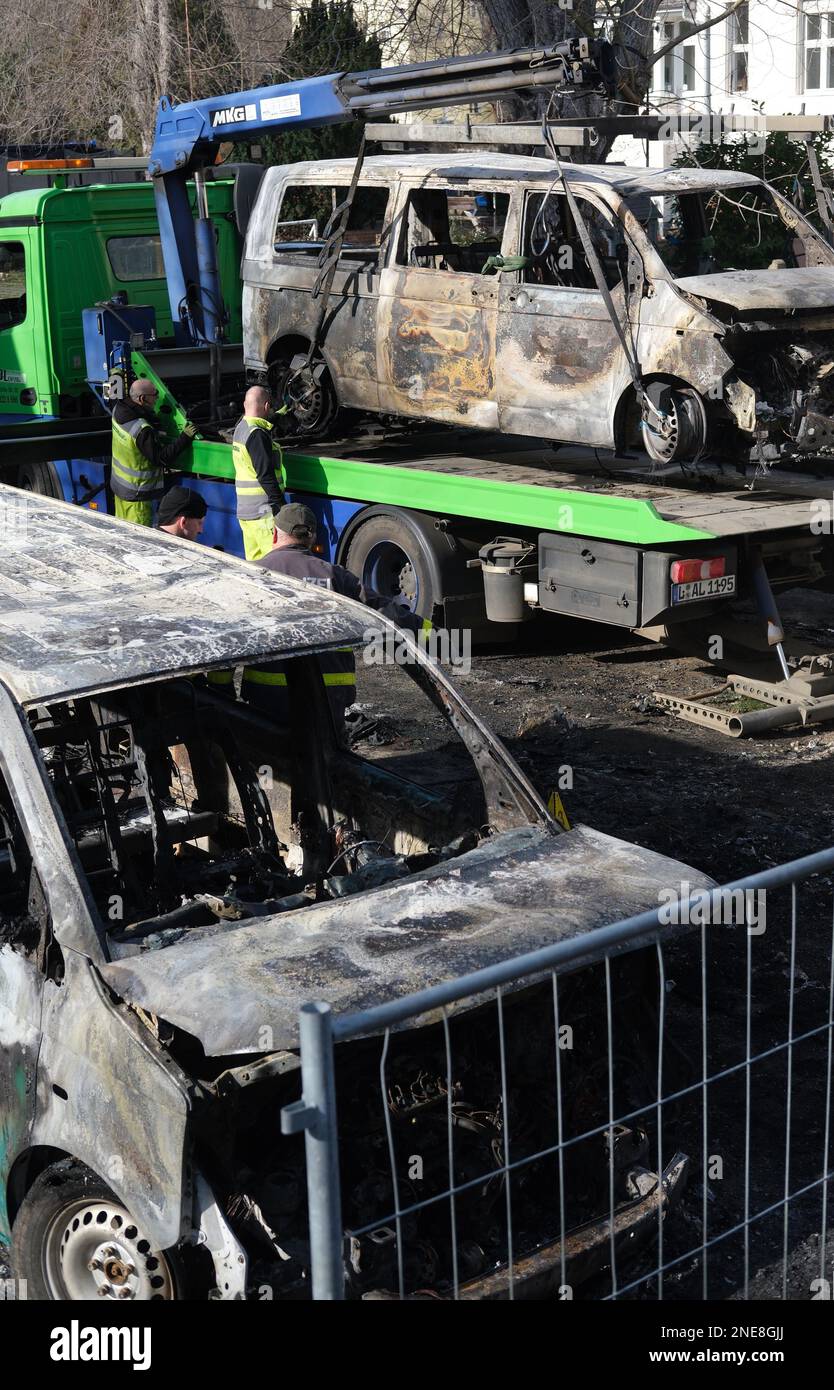 Leipzig, Germany. 16th Feb, 2023. Burned-out vehicles from the state-owned enterprise Sachsenforst are secured by the police. Two vans and two cars were apparently deliberately set on fire by unknown persons at the depot in the Connewitz district. The police suspect a political background. Credit: Sebastian Willnow/dpa/Alamy Live News Stock Photo