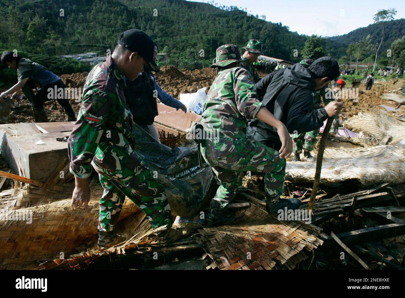 Rescuers evacuate the body of a landslide victim in Ciwidey district ...