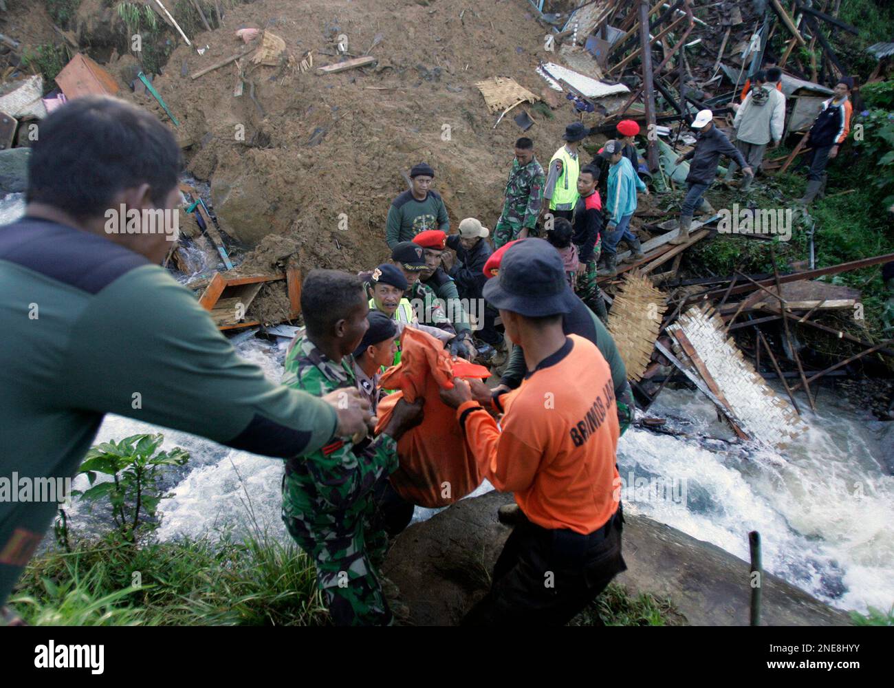 Rescuers evacuate the body of a landslide victim in Ciwidey district ...