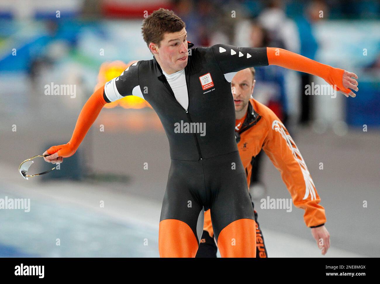 Netherlands's Sven Kramer throws his glasses away after being disqualified for he forgot to switch a lane during the men's 10,000 meter speed skating race at the Richmond Olympic Oval at the Vancouver 2010 Olympics in Vancouver, British Columbia, Tuesday, Feb. 23, 2010. At right is his coach Gerard Kemkers. (AP Photo/Chris Carlson) Stock Photo