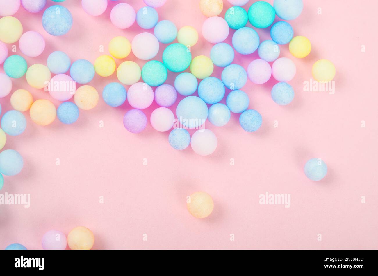 Colorful polystyrene foam on pink background, creativity concepts Stock Photo