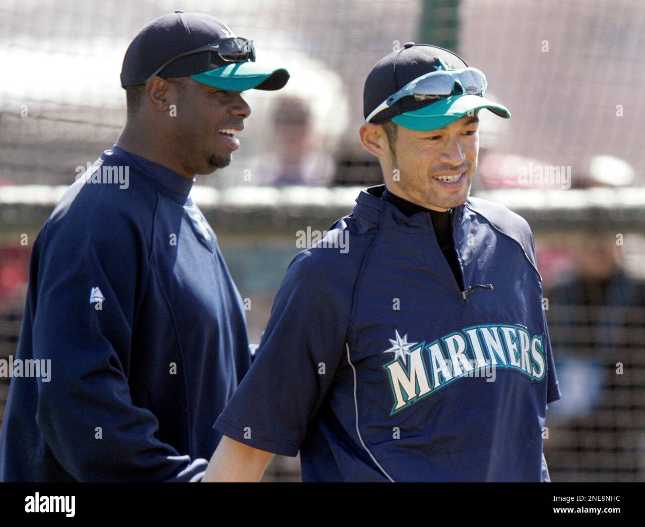 Seattle Mariners teammates Ken Griffey, Jr., left, and Ichiro Suzuki,  right, of Japan, walk off the practice field after taking batting practice  while working out at the team's baseball spring training facility