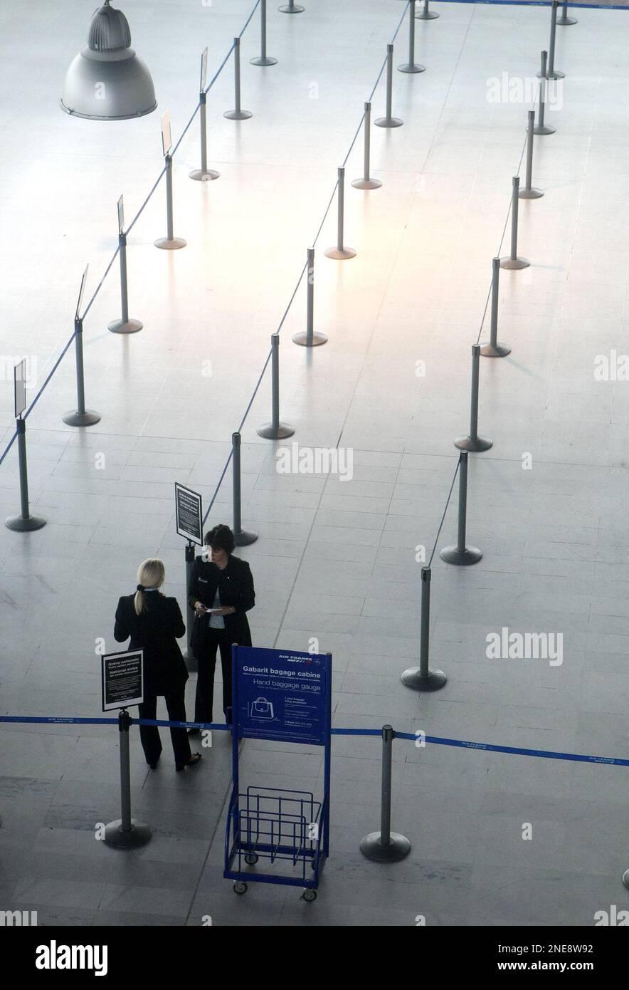 Ground personnel are seen at the departure desk at the Nice airport,  southeastern France, Tuesday Feb. 23, 2010. Hundreds of canceled or delayed  flights are expected as air traffic controllers begin a