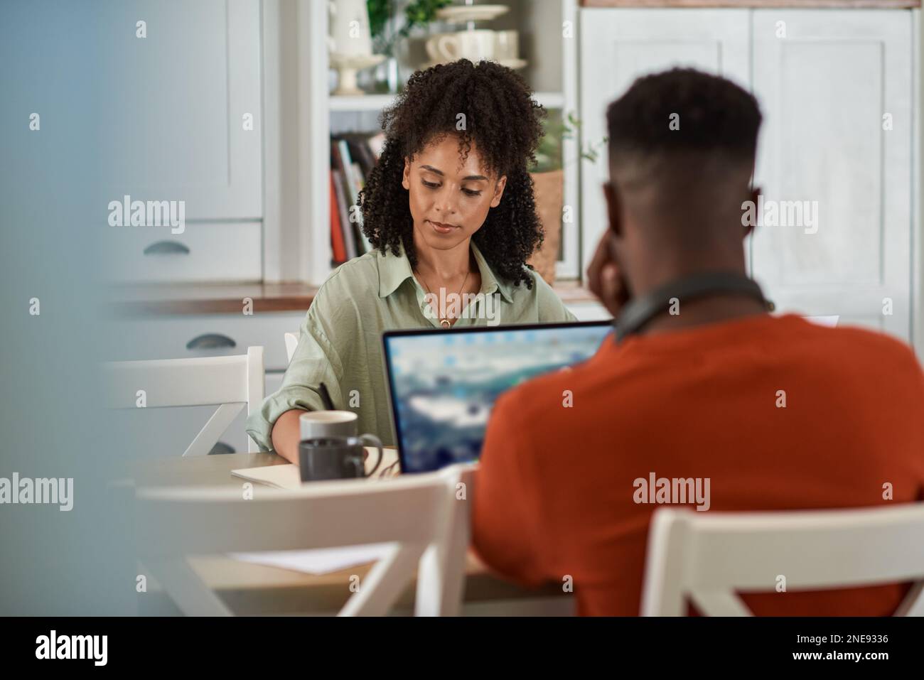 Multiracial couple working remotely from home on laptops Stock Photo