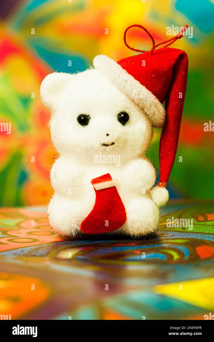 Christmas white soft toy kitten wearing a red and white hat. Stock Photo