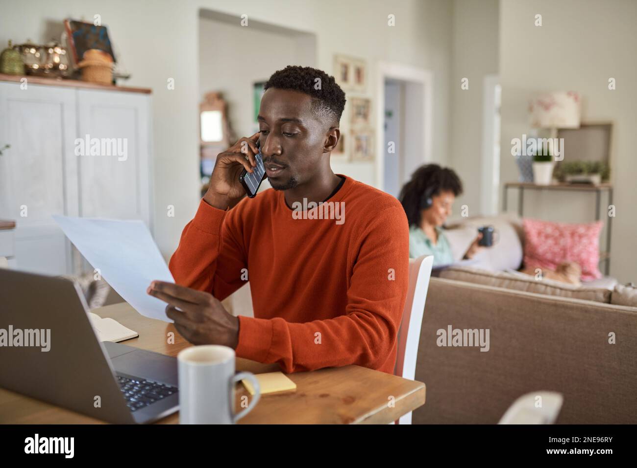 African man on a call while working remotely online from home Stock Photo