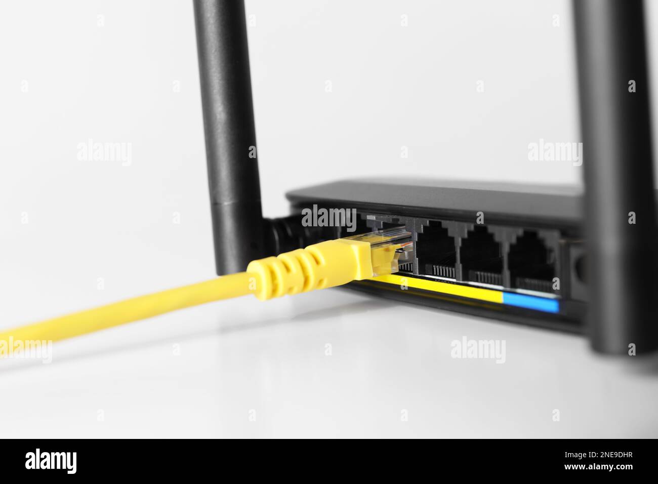 Connected cable to router on white table, closeup. Wireless internet ...