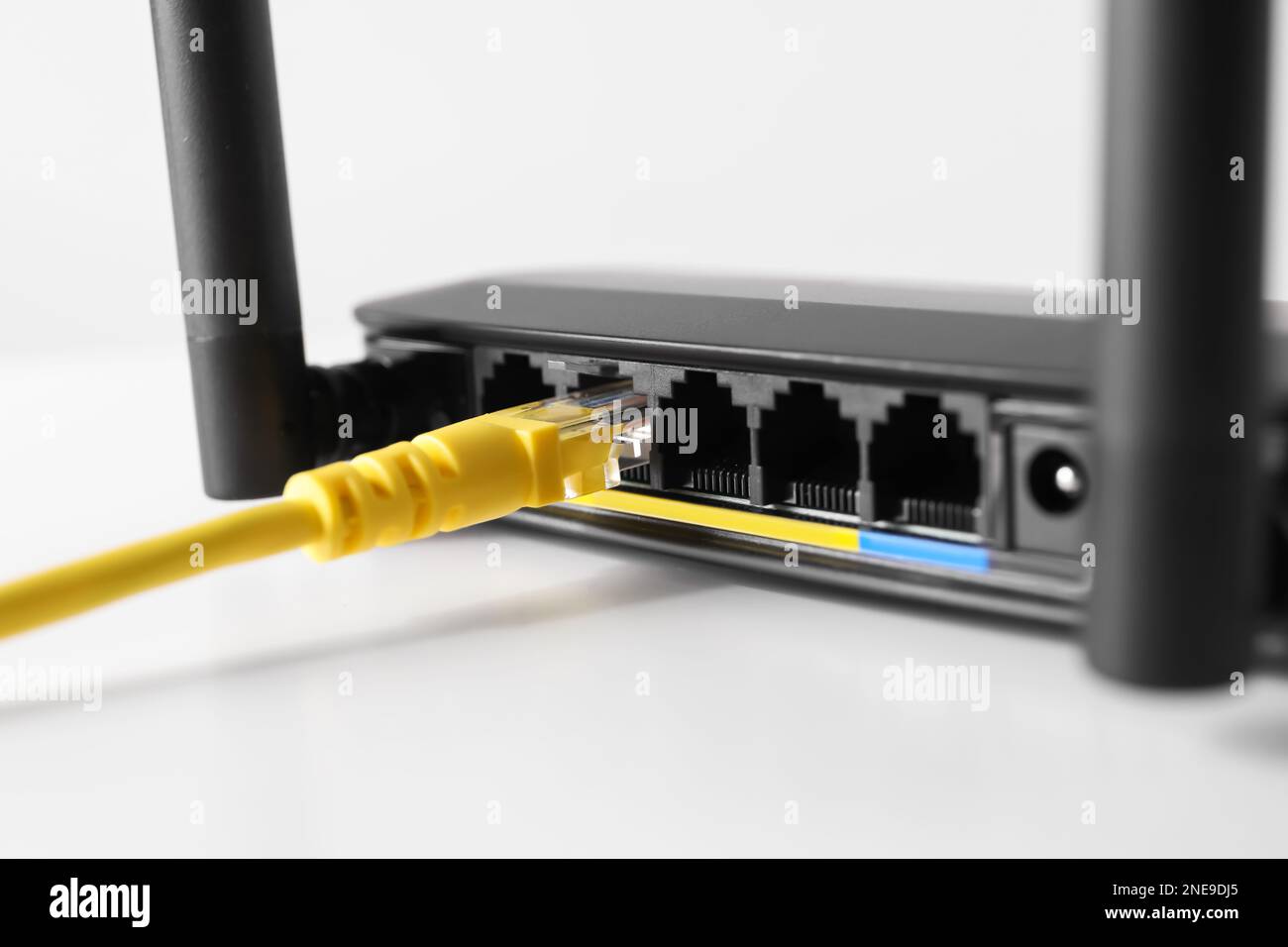 Connected cable to router on white table, closeup. Wireless internet ...