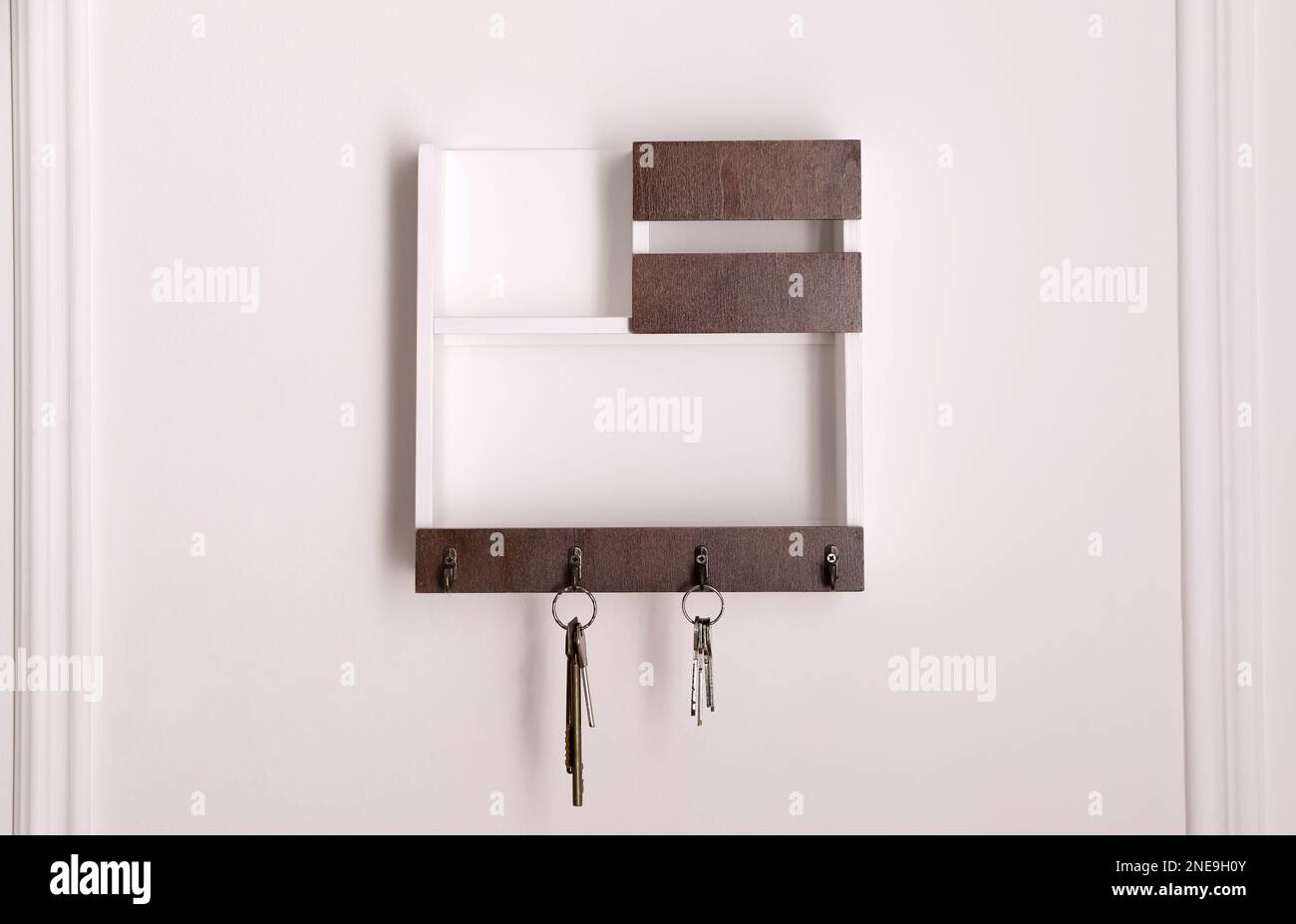 Wooden hanger for keys on white wall Stock Photo Alamy