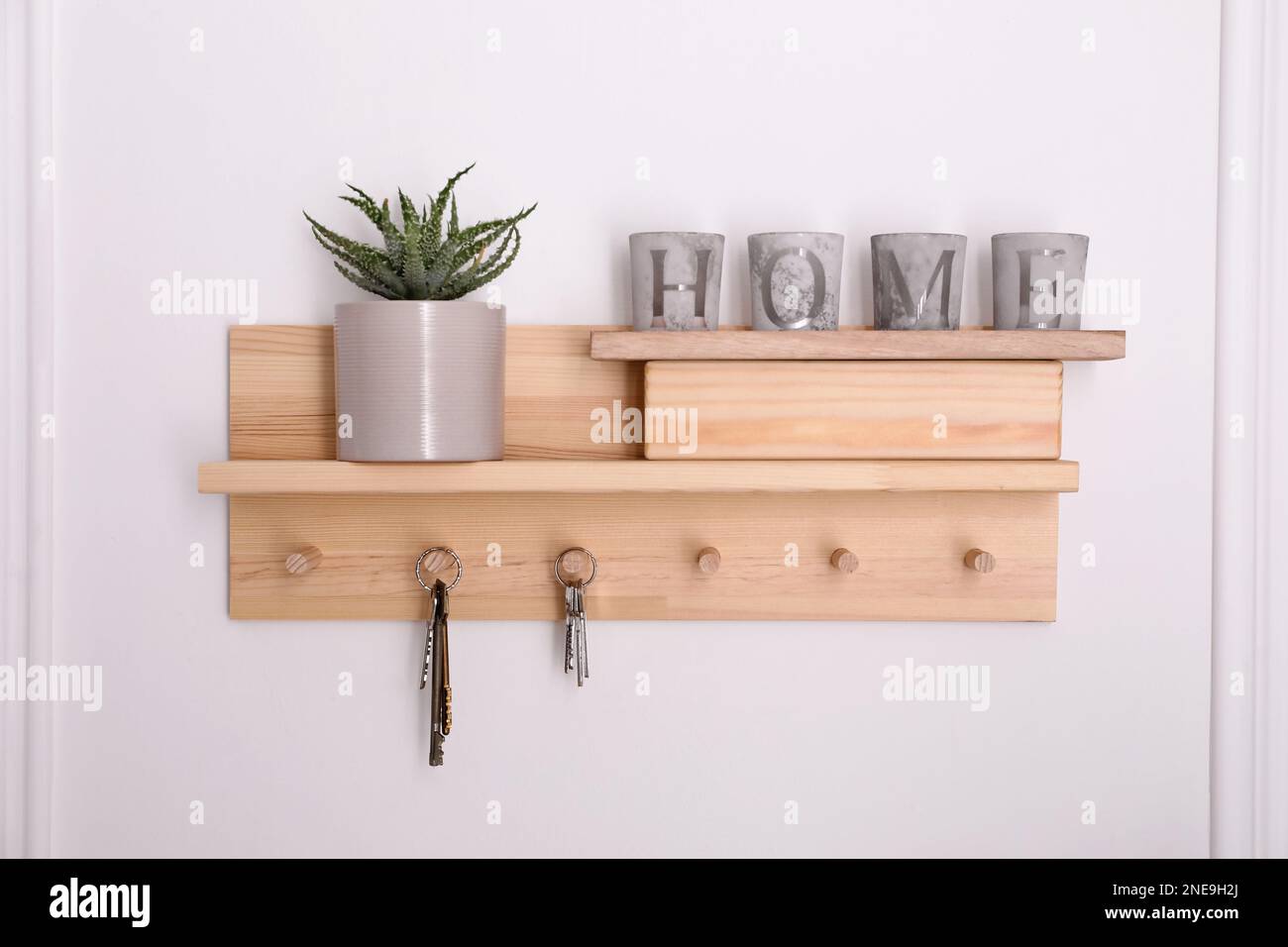 Wooden hanger for keys with decor on white wall Stock Photo Alamy