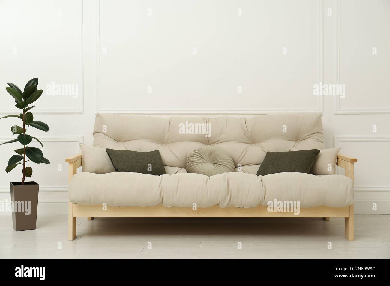 Stylish beige sofa in living room interior Stock Photo - Alamy