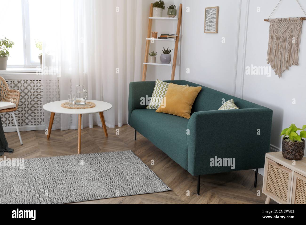 Stylish living room interior with comfortable sofa and small table ...