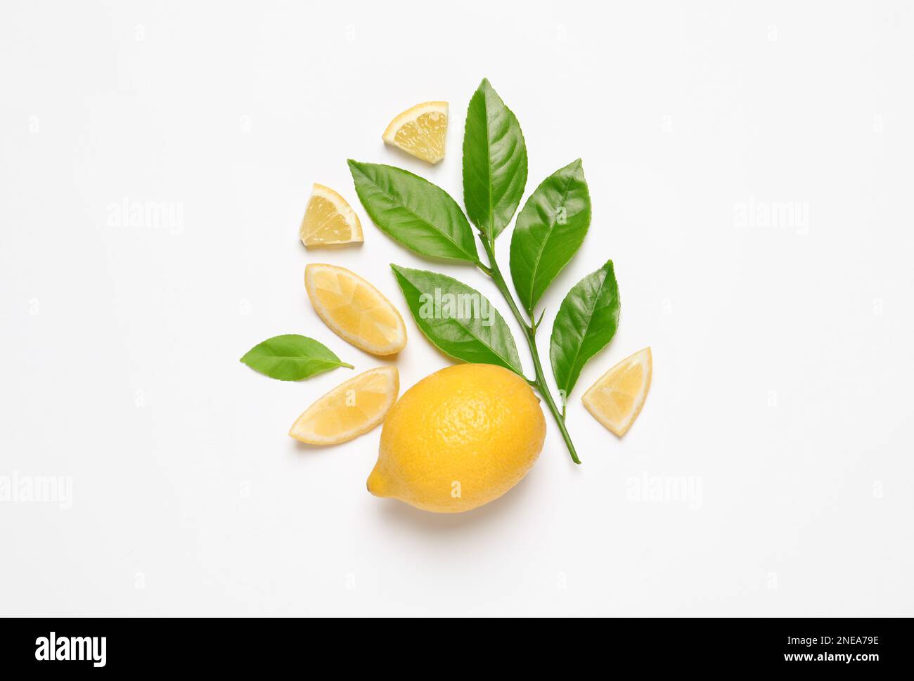 Whole and cut lemons with leaves on white background, top view Stock ...