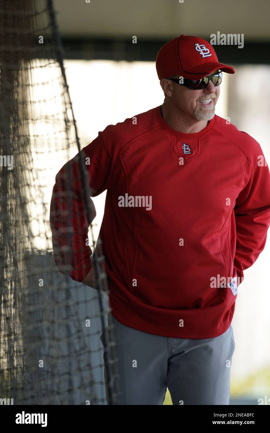 St. Louis Cardinals hitting coach Mark McGwire works with players in