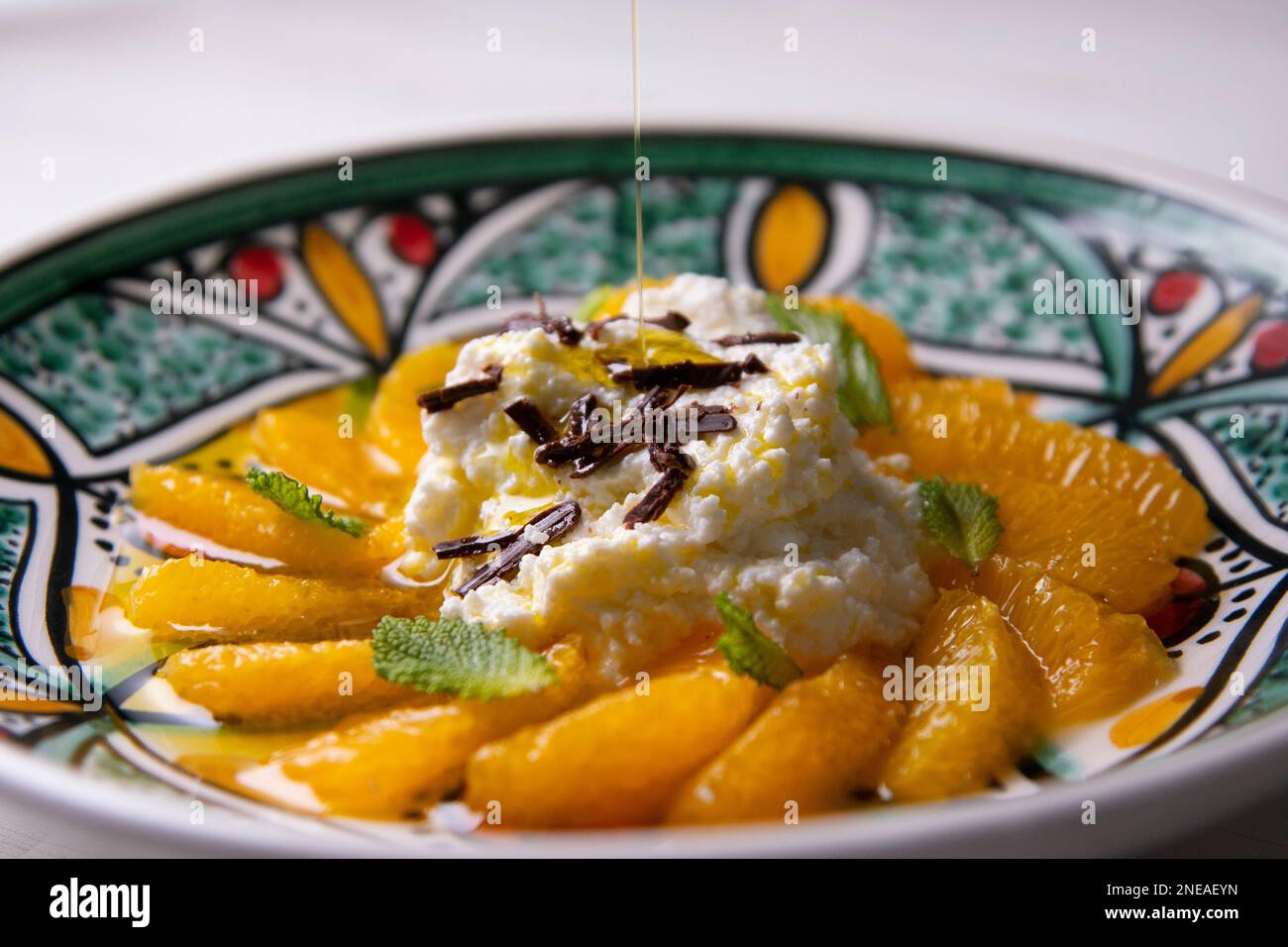 Spiced oranges with cloves and cinnamon served with organic honey and