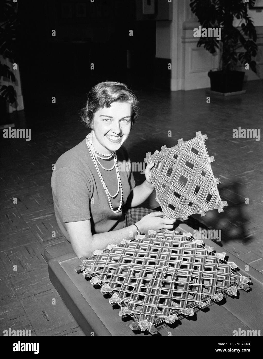 Barbara Yazdi displays two of the ghost traps that are laid on the floor or  hung on the wall to trap any ghost that dare enter a home in Tibet, March  23,