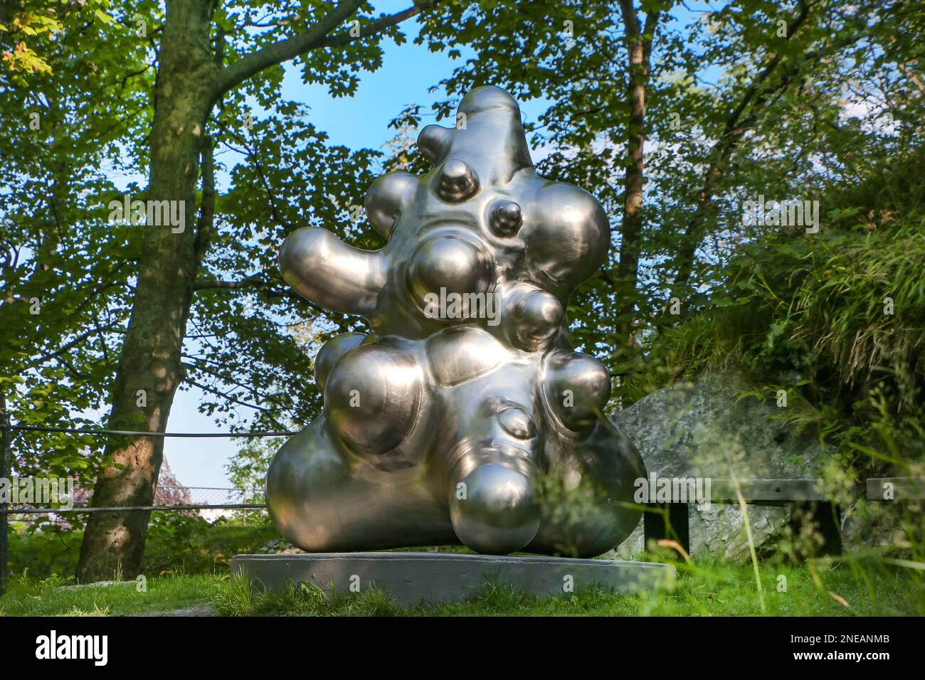 Abstract Statue Perception Silver abstract modern sculpture in a beautiful park in the city center ...