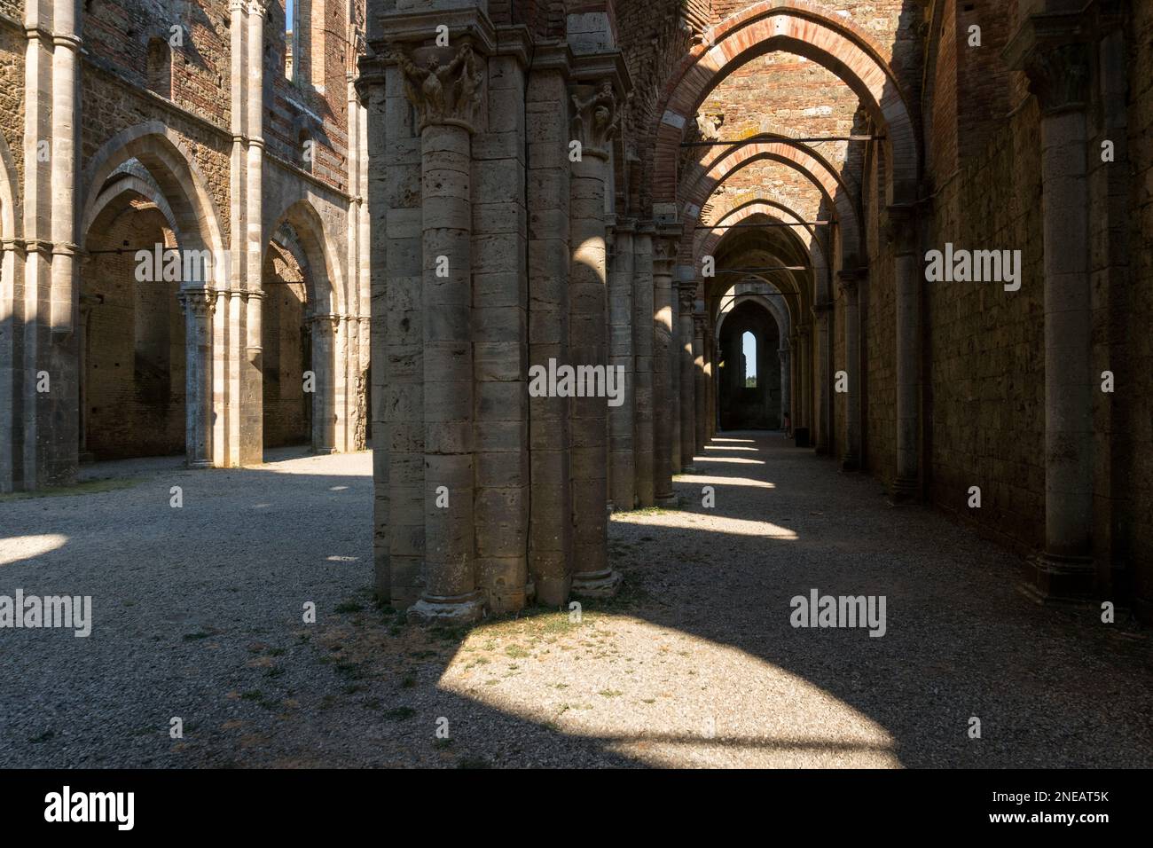 San Galgano ,Italy-august 8,2020:view of the interior of the abbey and former monastery of San Galgano famous for being roofless during a sunny day in Stock Photo