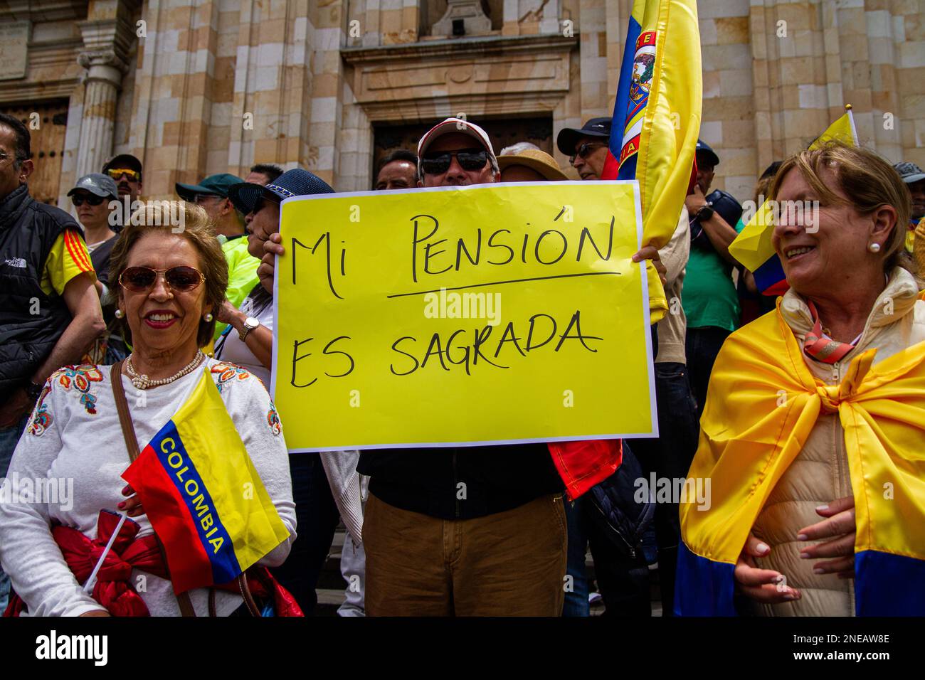 A demonstrator holds a banner that reads 'My pension is sacred' during the demonstrations against the reform proposals of Colombian president Gustavo Stock Photo