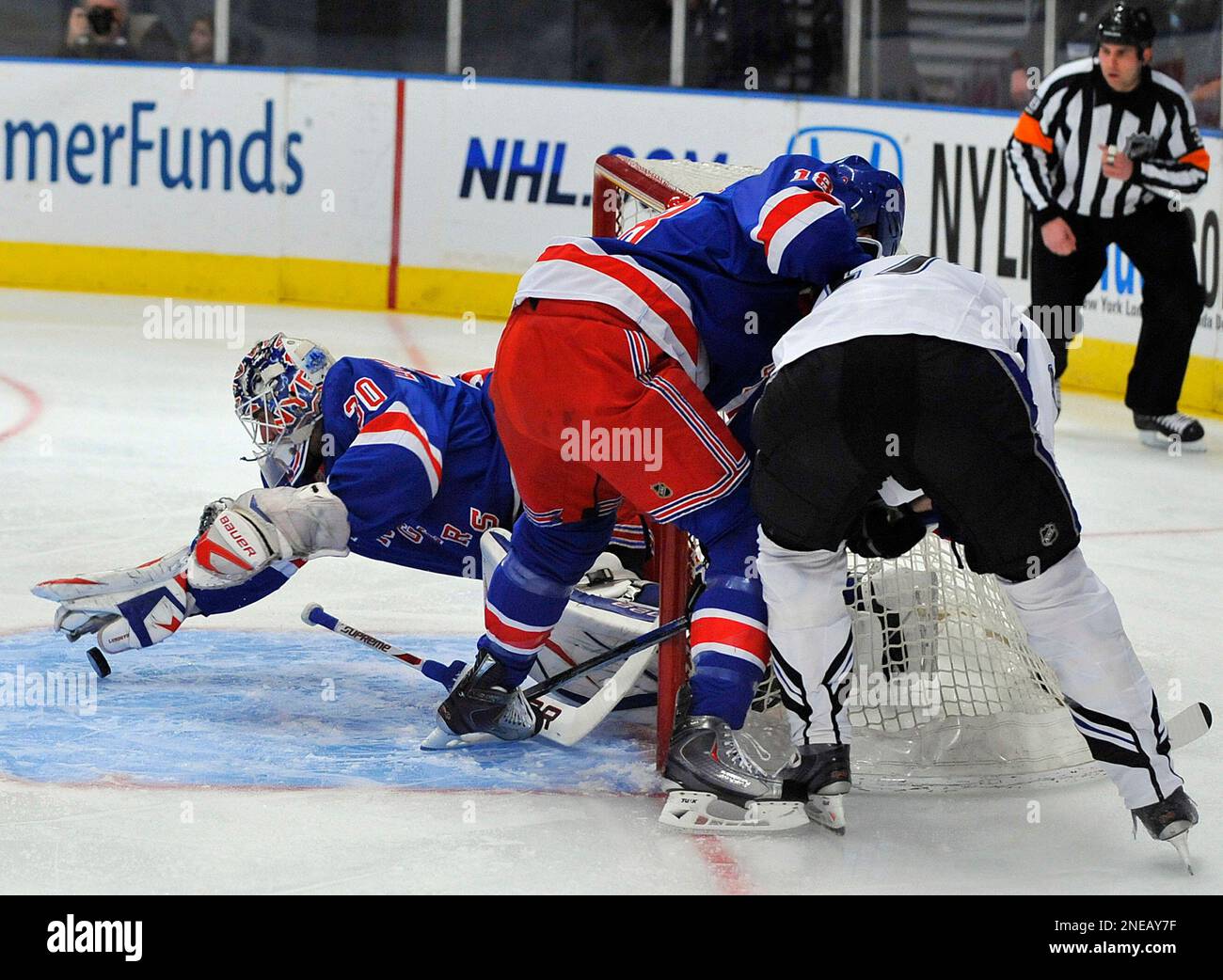 New York Rangers goalie Henrik Lundqvist, left, lunges for the puck in ...