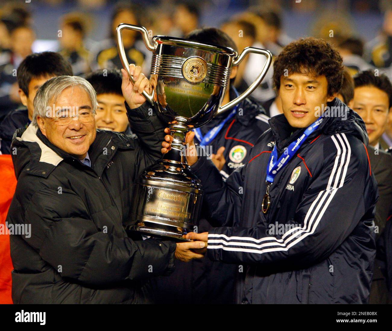 China's Du Wei receives the trophy during the award ceremony at the ...