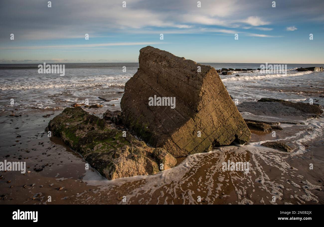 Remnants of old World War 2 concrete pill boxes on Fraisthorpe Beach near Bridlington, East Yorkshire, UK Stock Photo